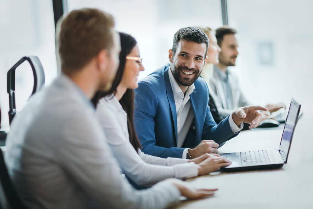 Stamford IT company employees work on laptop