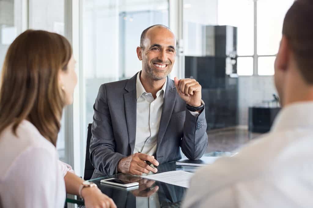 Insurance advisor in a meeting with man and woman.